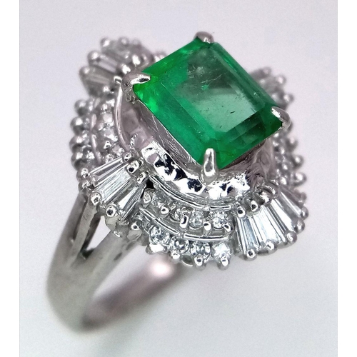 1143 - A SENSATIONAL 1.35ct EMERALD SURROUNDED BY QUALITY DIAMONDS AND DIAMOND BAGUETTES AND SET IN A PLATI... 