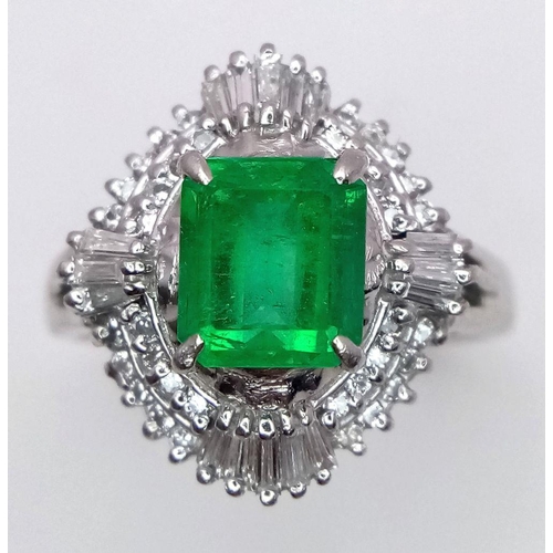 1143 - A SENSATIONAL 1.35ct EMERALD SURROUNDED BY QUALITY DIAMONDS AND DIAMOND BAGUETTES AND SET IN A PLATI... 