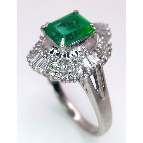 1143 - A SENSATIONAL 1.35ct EMERALD SURROUNDED BY QUALITY DIAMONDS AND DIAMOND BAGUETTES AND SET IN A PLATI... 