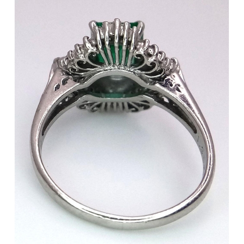 1143 - A SENSATIONAL 1.35ct EMERALD SURROUNDED BY QUALITY DIAMONDS AND DIAMOND BAGUETTES AND SET IN A PLATI... 