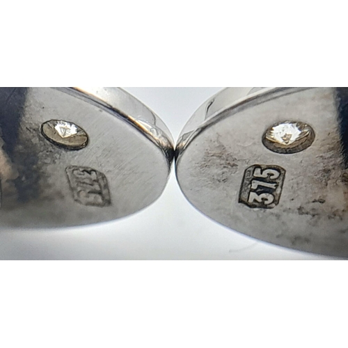 1383 - A Pair of 9K White Gold Diamond Set Cufflinks. 11.5g total weight.