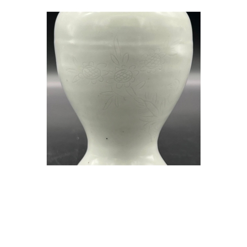 882 - A “sweet white” glazed two-handled vase with flower and bird pattern, Late Ming Dynasty. Minor chip ... 