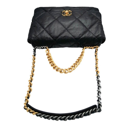 69 - A Large Chanel Quilted Black Leather Hand/Shoulder bag. Gold tone hardware. Outer pocket. Hand and s... 