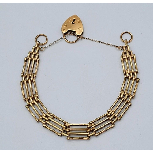 115 - A 9K Yellow Gold Gate Bracelet with Heart Clasp and Safety Chain. 16cm. 11.75g weight.