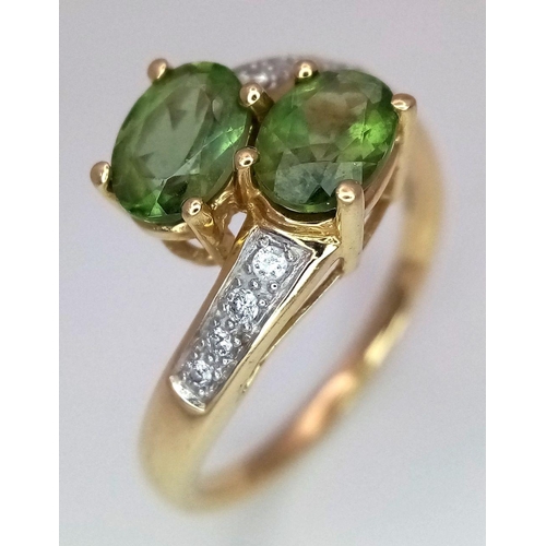 149 - A 14K Yellow Gold Diamond and Peridot Crossover Ring. Size P 1/2. 3.6g total weight.