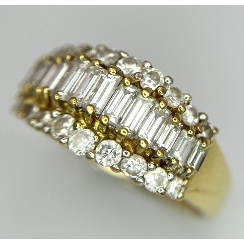 16 - An 18K Yellow Gold Three Row Diamond Ring. An extravagant central row of baguette cut diamonds with ... 