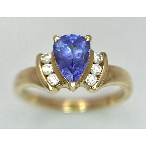 183 - A 14K Yellow Gold Diamond and Tanzanite Ring. A tanzanite shield with diamond accents! Size P. 3.9g ... 