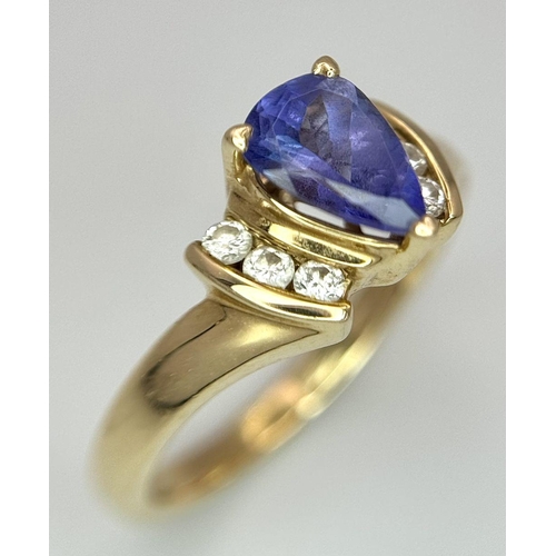 183 - A 14K Yellow Gold Diamond and Tanzanite Ring. A tanzanite shield with diamond accents! Size P. 3.9g ... 