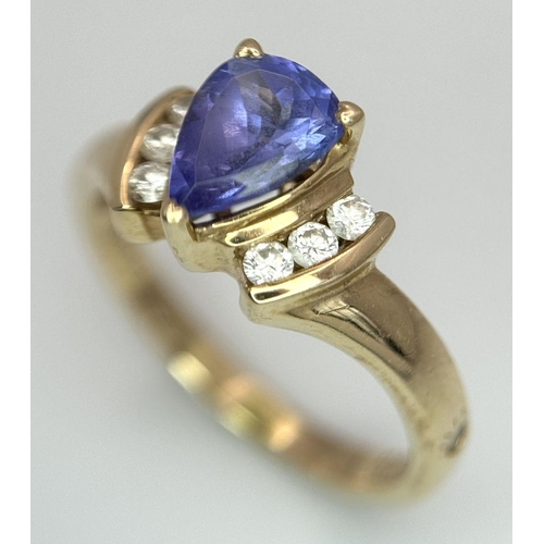 183 - A 14K Yellow Gold Diamond and Tanzanite Ring. A tanzanite shield with diamond accents! Size P. 3.9g ... 