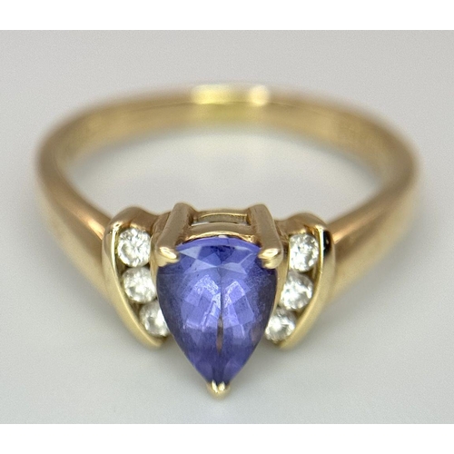 183 - A 14K Yellow Gold Diamond and Tanzanite Ring. A tanzanite shield with diamond accents! Size P. 3.9g ... 