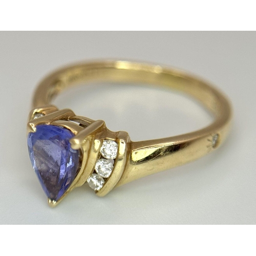 183 - A 14K Yellow Gold Diamond and Tanzanite Ring. A tanzanite shield with diamond accents! Size P. 3.9g ... 