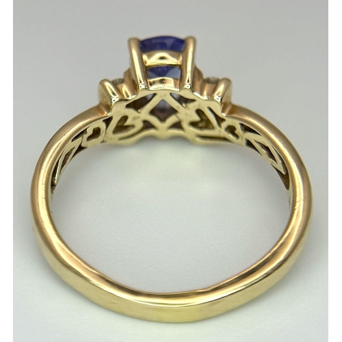 183 - A 14K Yellow Gold Diamond and Tanzanite Ring. A tanzanite shield with diamond accents! Size P. 3.9g ... 