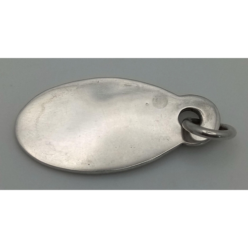 204 - A Sterling Silver Tiffany and Co. Pendant or Charm. Oval shape. 4.5cm. 14g