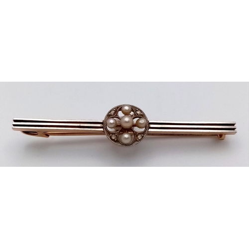 22 - An Antique 15K Gold and Platinum Bar Brooch. Seed pearl and diamond decoration. 5cm. 3.37g total wei... 