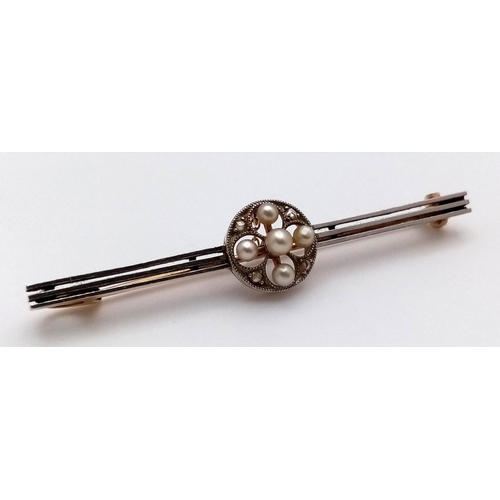 22 - An Antique 15K Gold and Platinum Bar Brooch. Seed pearl and diamond decoration. 5cm. 3.37g total wei... 