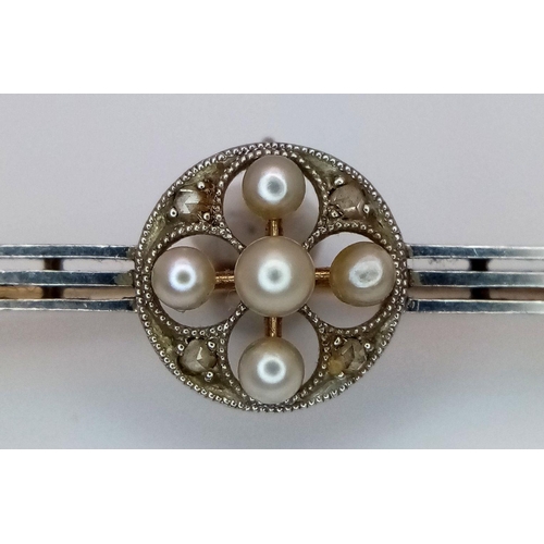 22 - An Antique 15K Gold and Platinum Bar Brooch. Seed pearl and diamond decoration. 5cm. 3.37g total wei... 