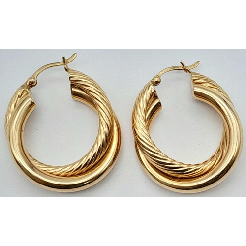 267 - A Pair of 14K Yellow Gold Stylish Hoop Crossover Earrings. 
3cm diameter. 5.4g weight.