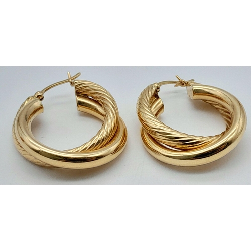 267 - A Pair of 14K Yellow Gold Stylish Hoop Crossover Earrings. 
3cm diameter. 5.4g weight.