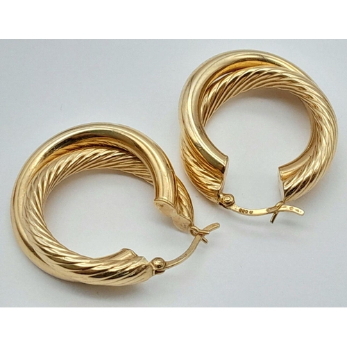 267 - A Pair of 14K Yellow Gold Stylish Hoop Crossover Earrings. 
3cm diameter. 5.4g weight.