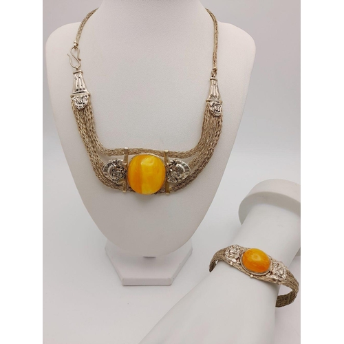 276 - A very attractive, white metal (untested), necklace and bracelet set with large amber coloured resin... 