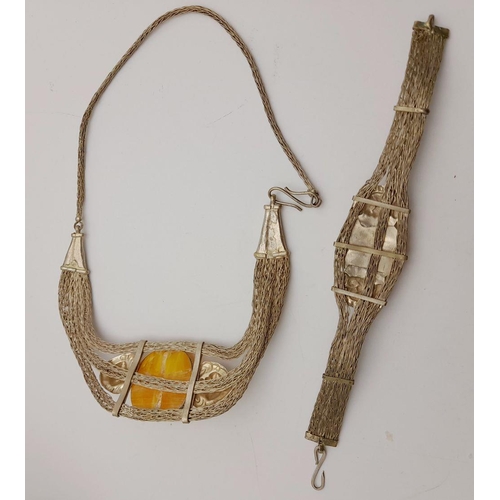 276 - A very attractive, white metal (untested), necklace and bracelet set with large amber coloured resin... 