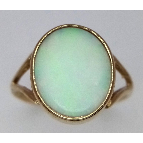 360 - A 9K Yellow Gold Opal Cabochon Ring. Size K. 2.1g total weight.