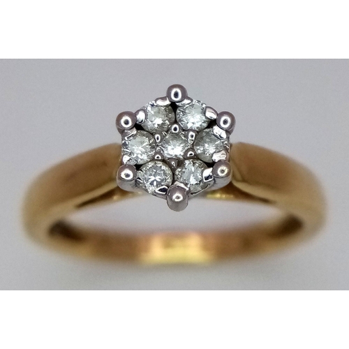 37 - An 18K Yellow Gold Diamond Ring. Seven small round cut diamonds. Size L. 3.25g total weight.