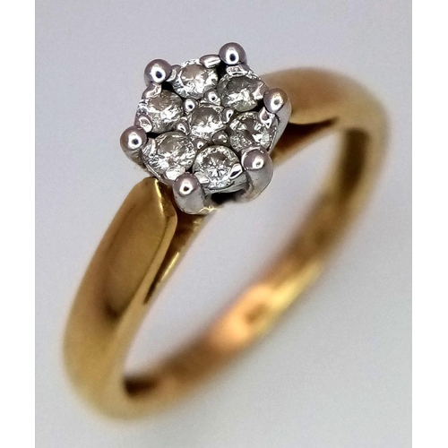 37 - An 18K Yellow Gold Diamond Ring. Seven small round cut diamonds. Size L. 3.25g total weight.