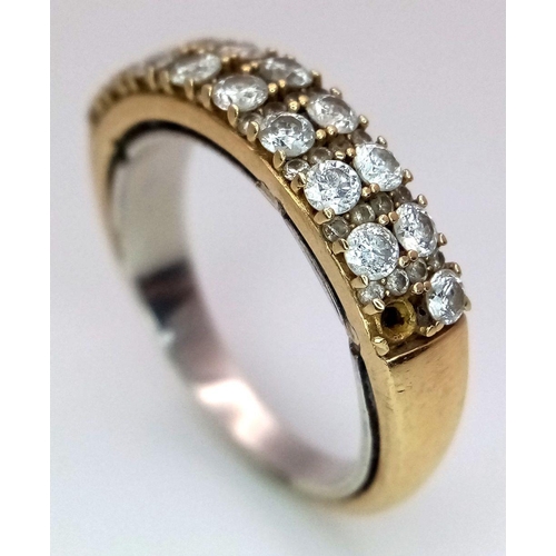 477 - An 18K Yellow Gold Two Row Diamond Ring. 19 round cut diamonds with diamond spacers. Note: There is ... 