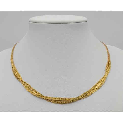 562 - A 9K Yellow Gold Crossover Flat Link Necklace. 36cm length. 12.45g weight.