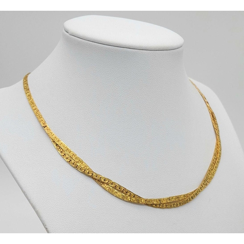 562 - A 9K Yellow Gold Crossover Flat Link Necklace. 36cm length. 12.45g weight.