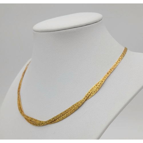 562 - A 9K Yellow Gold Crossover Flat Link Necklace. 36cm length. 12.45g weight.