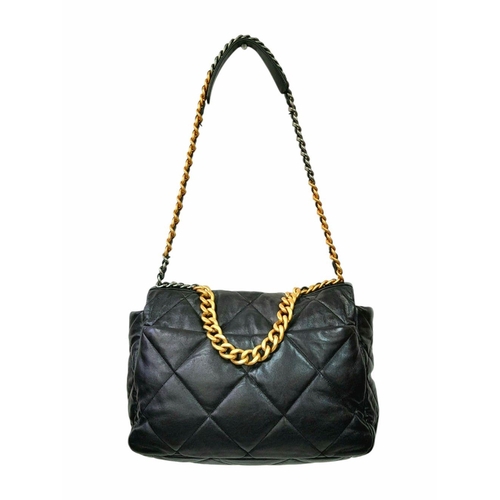 69 - A Large Chanel Quilted Black Leather Hand/Shoulder bag. Gold tone hardware. Outer pocket. Hand and s... 