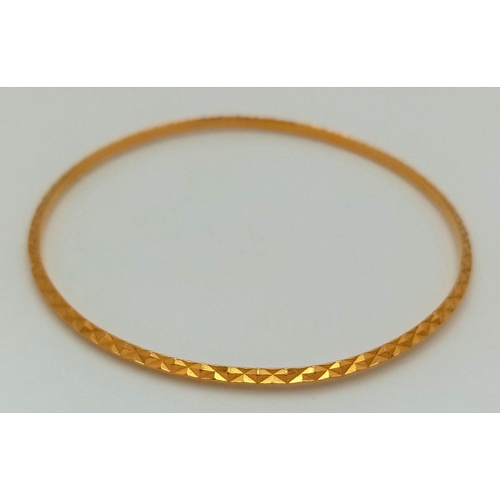 8 - A 22K Yellow Gold (tests as) Thin Bangle. 3mm width. 6cm inner diameter. 8.25g weight.