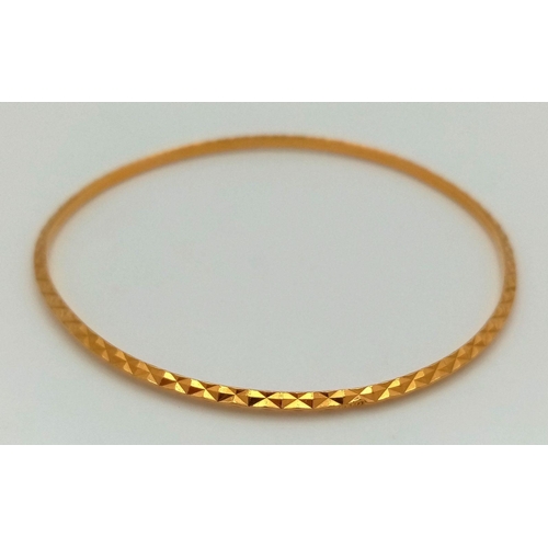 8 - A 22K Yellow Gold (tests as) Thin Bangle. 3mm width. 6cm inner diameter. 8.25g weight.