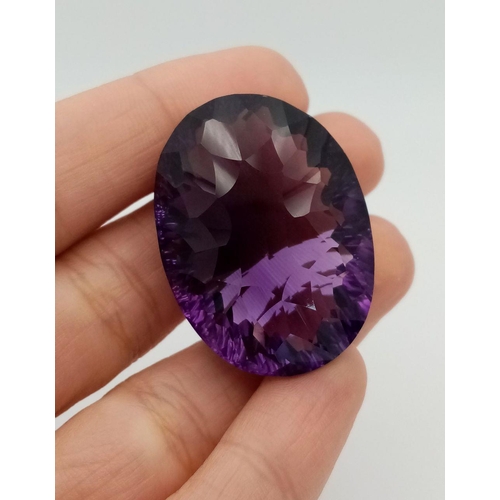 1129 - A 95.21ct Bolivian Amethyst Gemstone. Oval shape, concave cut. Comes with GFCO certificate. Ref: ZK ... 