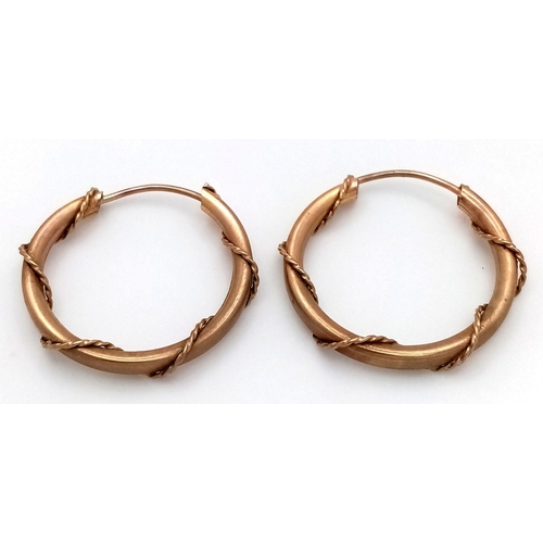 1374 - A Pair of 9K Yellow Gold Nautical-Esque Hooped Earrings. 
2cm diameter. 1.3g weight.