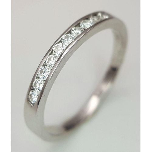 222 - AN 18K WHITE GOLD DIAMOND HALF ETERNITY RING. 0.20CT. 2.3G IN WEIGHT. SIZE Q AND 1/2. Ref: SC 6099