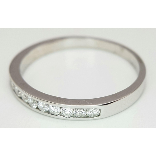 222 - AN 18K WHITE GOLD DIAMOND HALF ETERNITY RING. 0.20CT. 2.3G IN WEIGHT. SIZE Q AND 1/2. Ref: SC 6099