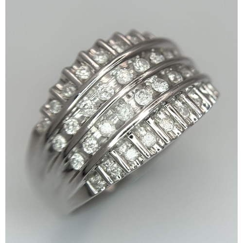 418 - A 9K WHITE GOLD DIAMOND SET 4 ROW BAND RING 0.25CT. 4.6G IN WEIGHT. SIZE O. Ref: SC 6033.