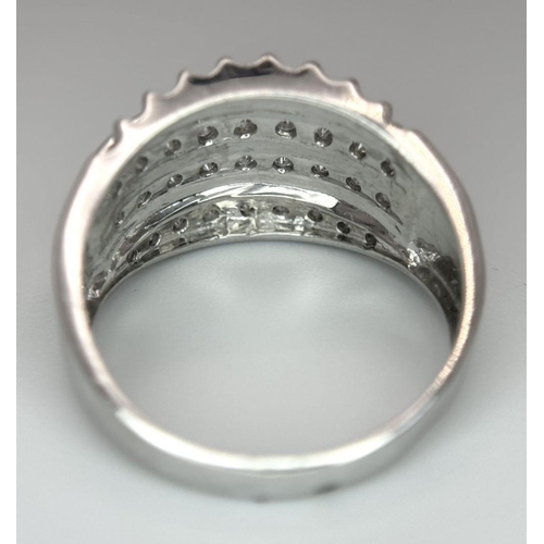 418 - A 9K WHITE GOLD DIAMOND SET 4 ROW BAND RING 0.25CT. 4.6G IN WEIGHT. SIZE O. Ref: SC 6033.