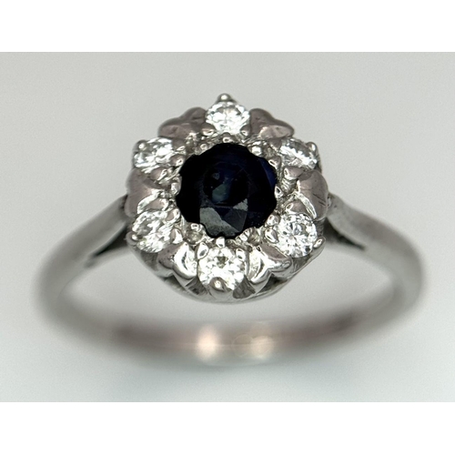 445 - AN 18K WHITE GOLD DIAMOND & SAPPHIRE CLUSTER RING 4.2G SIZE O 1/2. Ref: SC 6024