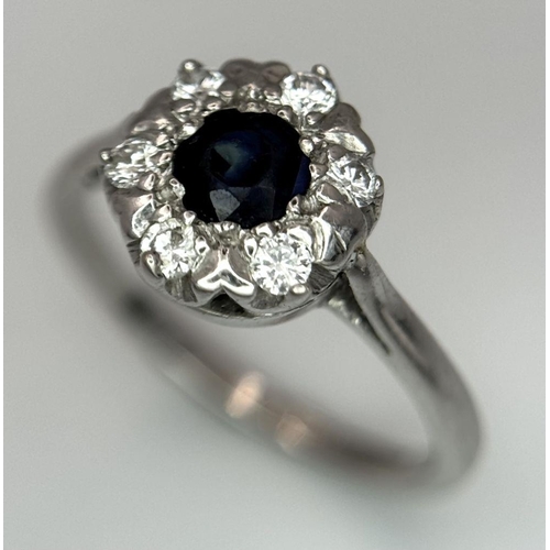 445 - AN 18K WHITE GOLD DIAMOND & SAPPHIRE CLUSTER RING 4.2G SIZE O 1/2. Ref: SC 6024