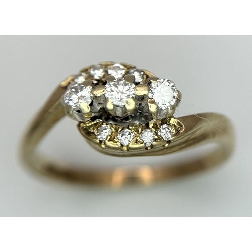 565 - A 9K YELLOW GOLD DIAMOND 3 STONE TWIST RING WITH DIAMOND ACCENT SHOULDERS. 2.5G IN WEIGHT. SIZE N. R... 