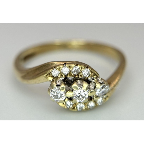 565 - A 9K YELLOW GOLD DIAMOND 3 STONE TWIST RING WITH DIAMOND ACCENT SHOULDERS. 2.5G IN WEIGHT. SIZE N. R... 