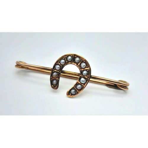 612 - An Antique 9K Gold Safety Pin Bar Brooch with Seed Pearl Horseshoe Decoration. 3cm. 1.25g total weig... 