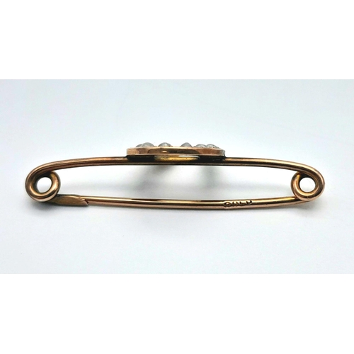 612 - An Antique 9K Gold Safety Pin Bar Brooch with Seed Pearl Horseshoe Decoration. 3cm. 1.25g total weig... 