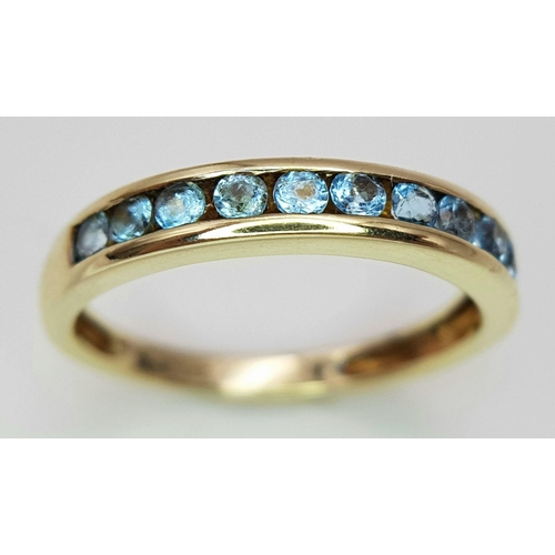 621 - A 9K YELLOW GOLD TOPAZ SET BAND RING. 1.8G IN WEIGHT. SIZE M. Ref: SC 6057