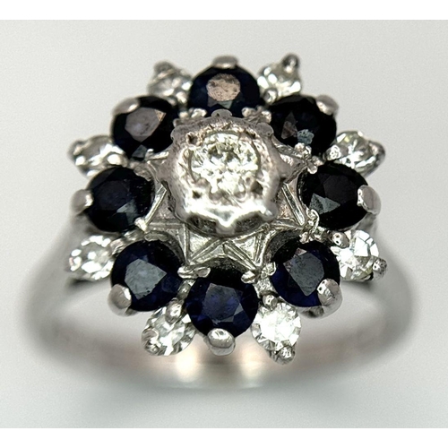 74 - AN 18K WHITE GOLD DIAMOND & SAPPHIRE CLUSTER RING. 5.2G IN WEIGHT. SIZE J. Ref: SC 6094