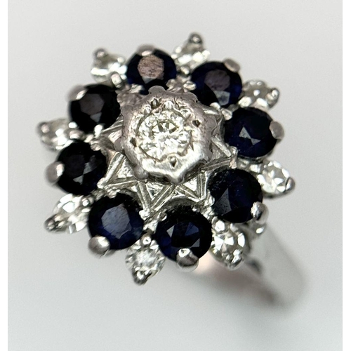 74 - AN 18K WHITE GOLD DIAMOND & SAPPHIRE CLUSTER RING. 5.2G IN WEIGHT. SIZE J. Ref: SC 6094